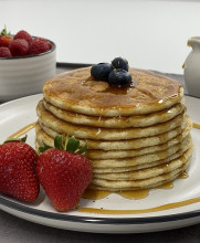 protein pancakes on white plate with syrup and fruit 2